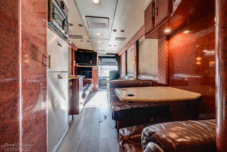 Prevost XLII interior view from galley toward rear lounge with seating and workspace