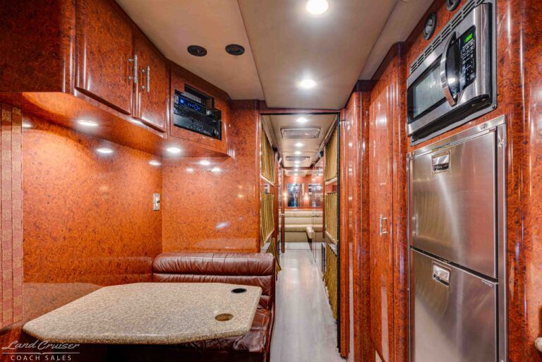 Prevost XLII galley hallway with refrigerator and cabinetry in crew bus conversion